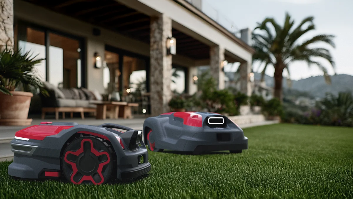 Robot tondeuse Cramer AiConic rouge et gris en train de tondre une pelouse résidentielle bien entretenue